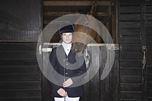 Female Horseback Rider With Horse In Stable