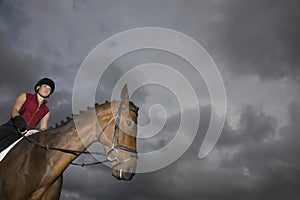 Female Horseback Rider Sitting On Horse