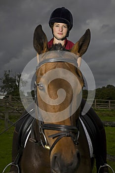 Female Horseback Rider Sitting On Horse