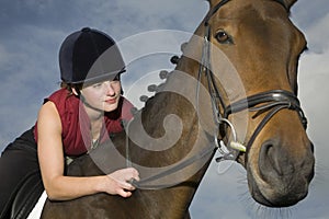 Female Horseback Rider Sitting On Horse