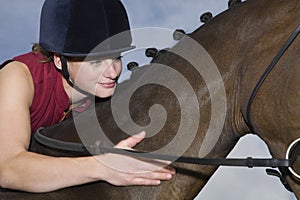 Female Horseback Rider Stroking Horse