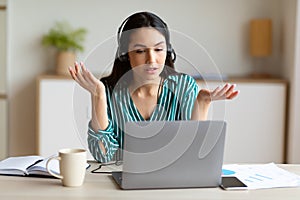 Female Hotline Worker Talking Wearing Headset Sitting In Call Center