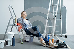 Female house painter relaxing on a lagger photo
