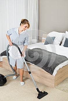 Female Housekeeper With Vacuum Cleaner