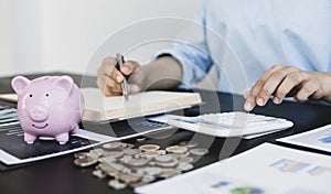 Female housekeepers are calculating using graphs and calculators to make family expenses in order to save money and be used in the