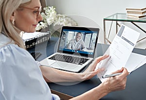 Female hr reading cv during online virtual job interview by video call. photo