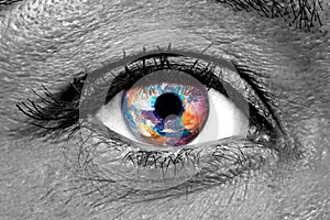 Female human eye closeup with Earth impressed on the iris photo