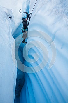 Female ice climber in narrow canyon on the Matanuska Glacier