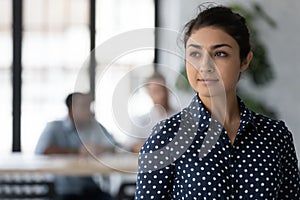 Female indian employee look in distance thinking of career opportunities