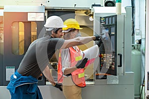 Female industrial engineers have to consult with colleague while using clipboard