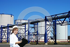 Female inpector performing an audit of tank farm