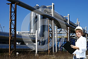 Female inpector performing an audit of tank farm