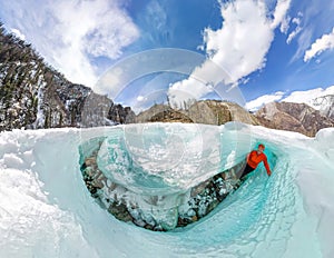 Female inside the crack in the ice glaciers Iceland. Wide-angle panorama