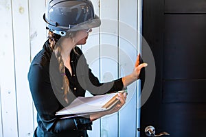 Female inspector reviews a room door photo