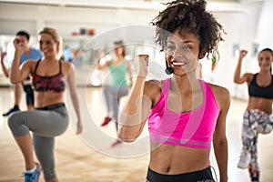 Female instructor with headset in fitness class