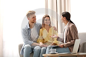 Female insurance agent working with young couple