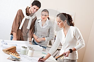 Female interior designer with two clients