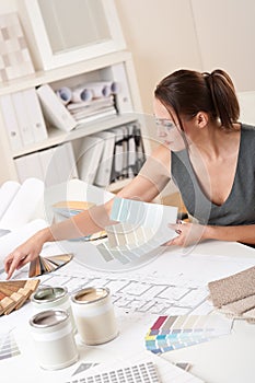 Female interior designer working with color swatch