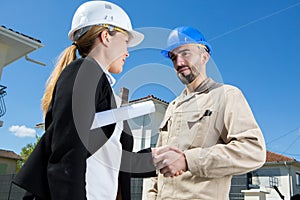 female investor and contractor shaking hands