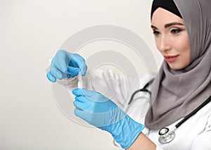 Arab female doctor on white studio background