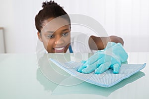 Female Janitor Cleaning Desk