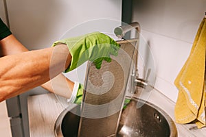 Female janitor with cleaning supplies in kitchen