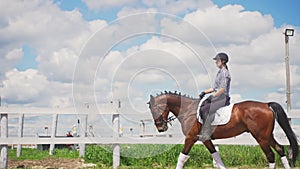 Female Jockey Riding On The Back Of Her Dark Bay Horse - Horse Wearing Stockings