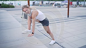 Female jogger lunging on steps