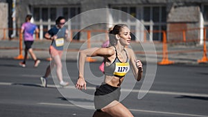 Female jogger run marathon. Woman champion athlete overtake men. Sportswoman jog