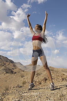 Female Jogger Stretching Her Arms Outdoors