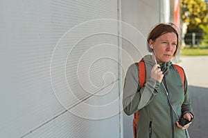 Female jogger talking on mobile phone handsfree