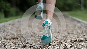 Female jogger on a track between trees