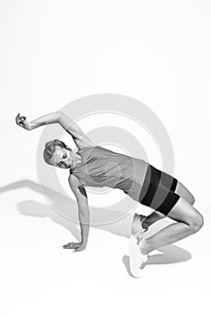 Female In Jogging Outfit During Body Flex and Stretching Exercises On White Background. Black and White