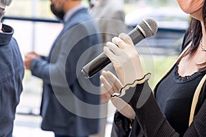 Female journalist at media event or news conference during coronavirus COVID-19 pandemic