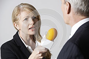 Female Journalist With Microphone Interviewing Businessman