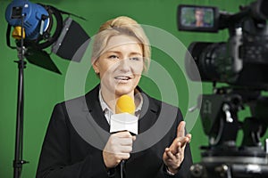 Female Journalist Presenting Report In Television Studio photo