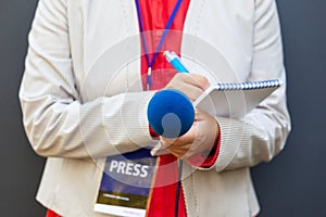 Female journalist or reporter at news conference or media event. Journalism concept. photo