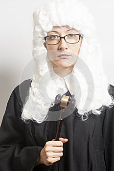 Female judge wearing a wig and Back mantle with eyeglasses