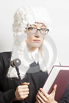 Female judge wearing a wig and Back mantle with eyeglasses