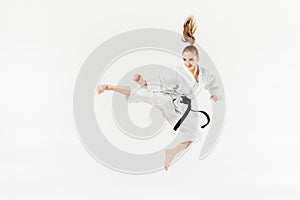 female karate fighter jumping and performing kick