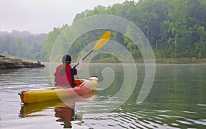 Female kayaker on lake