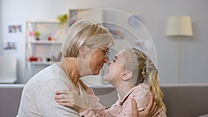 Female kid and granny nuzzling, family generations, love connection, closeness