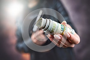 female killer hold gun pistol and stack of dollar