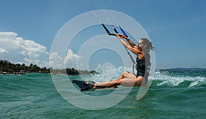 Female Kite surfer riding a kiteboard on the sea