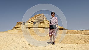 Female Korean tourist at Gebel Al Mawta, the `Mountain of the Dead`, in Siwa Oasis, Egypt.