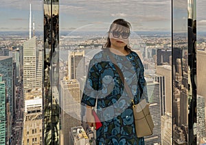 Female Korean tourist posing in the immersive art experience of SUMMIT One Vanderbilt in New York City.