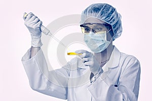 Female lab technician with pipette and liquid