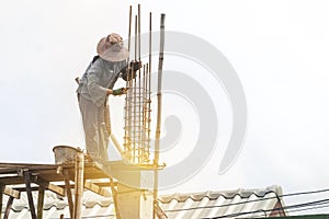 Female labor working at concstruction site, girl building house