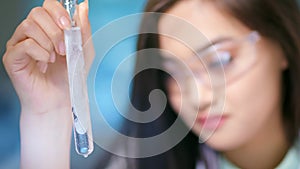 Female laboratory assistant studying genetic material preparing to IVF extracorporeal fertilization