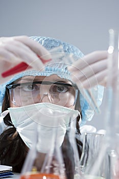 Female Laboratory Staff Conducting Experiment with Two Liquid Specimens